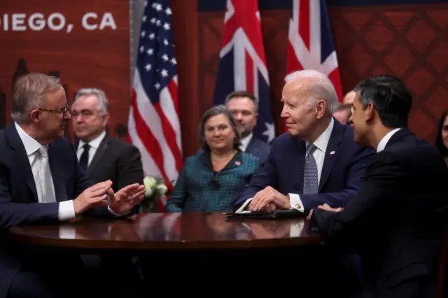 Joe Biden, Rishi Sunak and Anthony Albanese gathered at a table for talks