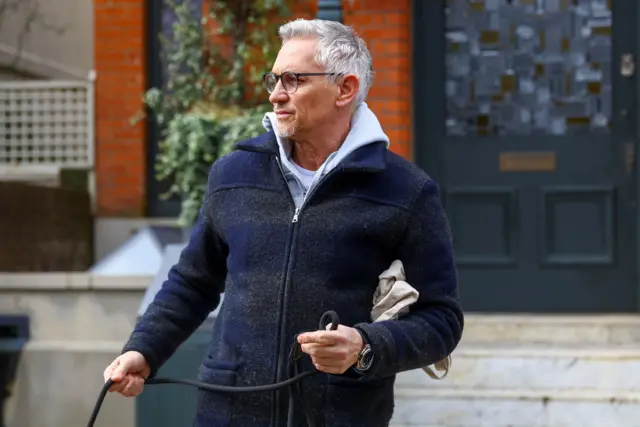 Gary Lineker holding dog leash outside his London home