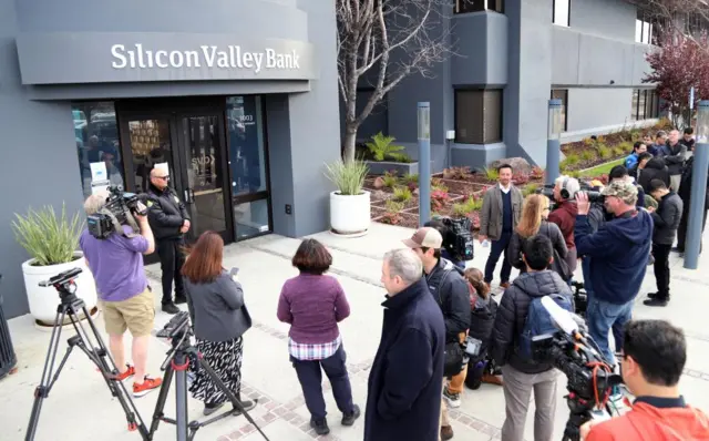 Customers wait outside the headquarters of Silicon Valley Bank (SVB) in Santa Clara, California