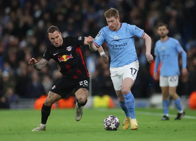 RB Leipzig's David Raum in action with Manchester City's Kevin De Bruyne