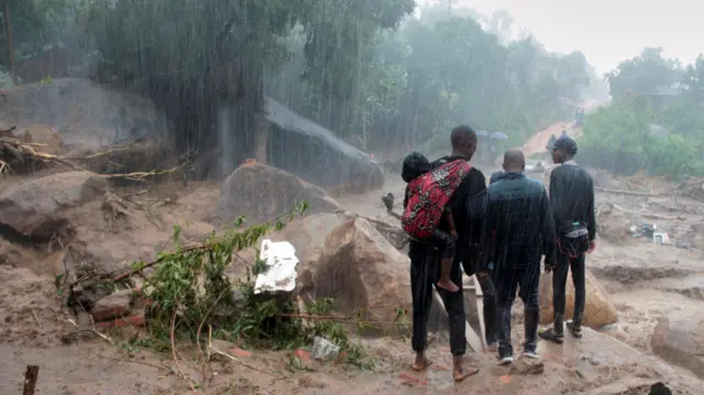 People look at the damage caused by Cyclone Freddy in Chilobwe, Blantyre, Malawi, March 13, 2023.