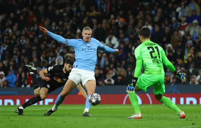 Manchester City's Erling Braut Haaland in action with RB Leipzig's Janis Blaswich