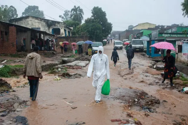 Residents walk in a street in Blantyre on March 14, 2023, following heavy rains after cyclone Freddy made landfall.