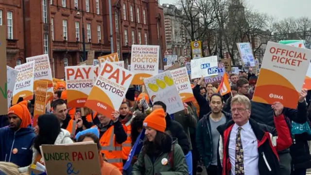 Doctors holding signs