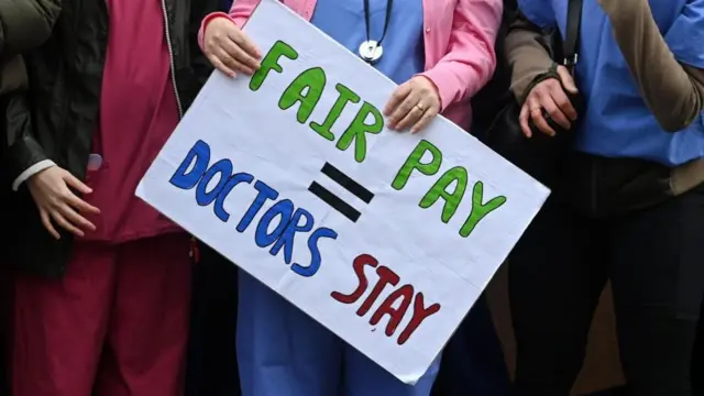 The legs of junior doctors rallying outside Downing Street in London, Britain, 13 March 2023.