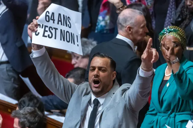 French member of Parliament Sebastien Delogu holds protest sign reading 'No to 64 years old' at the National Assembly in Paris