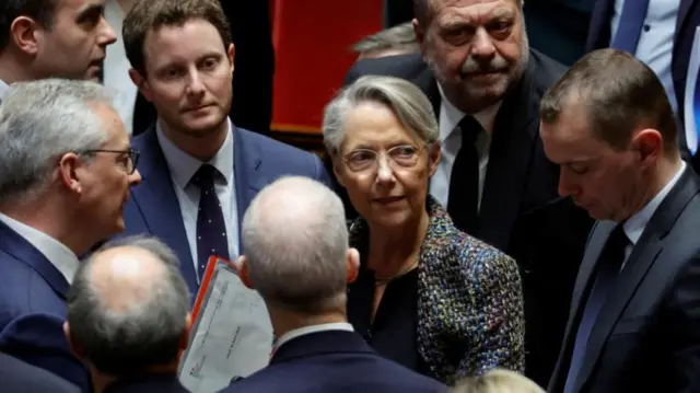 French Prime Minister Elisabeth Borne is surrounded by members of the French government