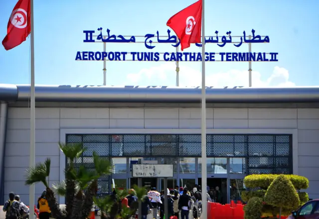 Migrants arrive at Tunis-Carthage International airport on March 7, 2023 as they prepare to leave Tunis on a repatriation flight.