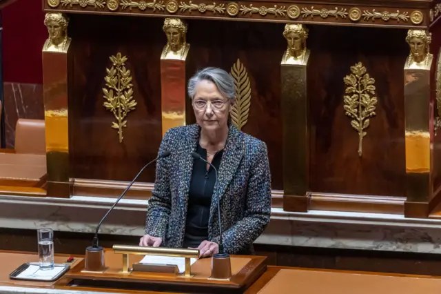 Prime Minister Elisabeth Borne at the podium in the National Assembly chamber