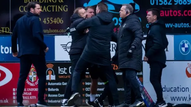 Swansea assistant coach Matt Gill (second left) tangles with Luton boss Rob Edwards during the melee which saw Russell Martin (left) and Luton assistant Richie Kyle (right) shown red cards