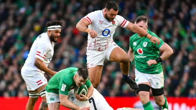 Johnny Sexton is tackled by England players