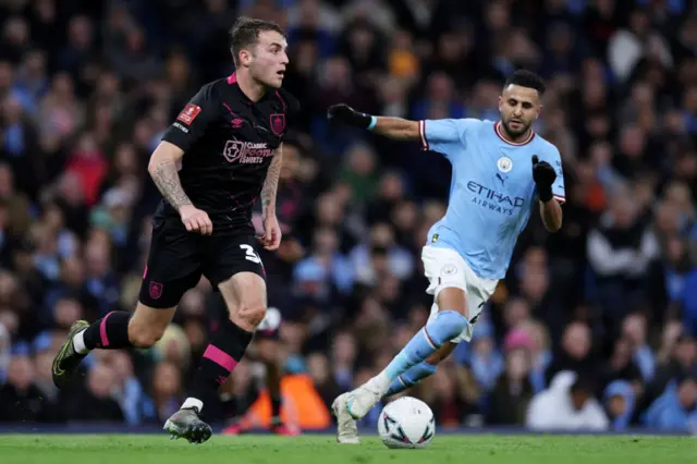 Riyad Mahrez dribbles as Man City face Burnley