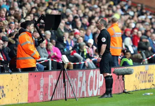 Referee Tim Robinson checks the pitch side VAR monitor before awarding a penalty to Blackburn Rovers during the Emirates FA Cup quarter final match at Bramall Lane, Sheffield