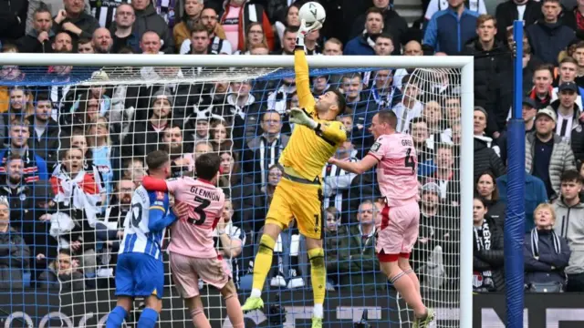 Max Crocombe tips the ball over his goal