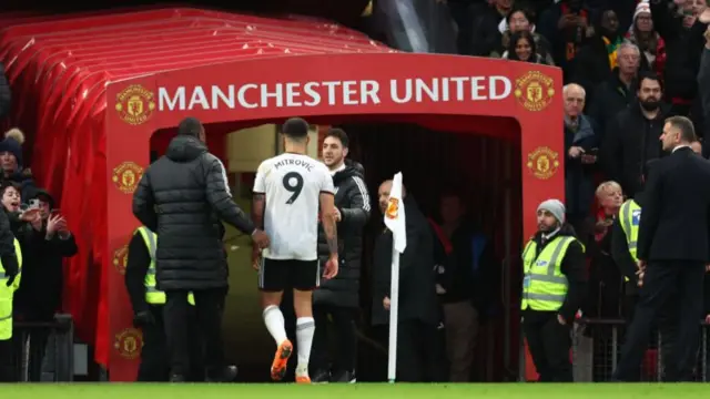 Aleksandar Mitrovic walks down Old Trafford tunnel