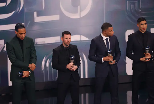 Lionel Messi picks up an award