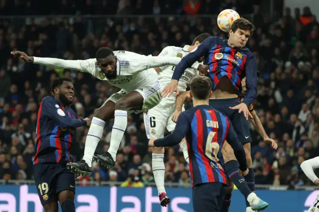 Antonio Rudiger and Marcos Alonso jump to contest a header