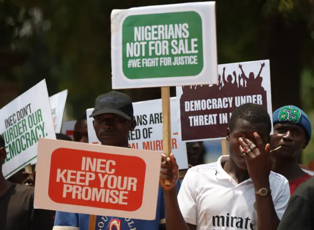 A group of people displays placards to protest the outcome of the 2023 presidential elections and the emergence of the candidate of All Progressives Congress' (APC) Bola Tinubu as the president-elect in Abuja