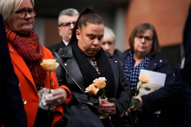 Victims' families listen to Scorer reading their statement