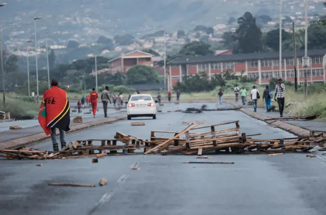 A barricade is seen in the road as members of the Economic Freedom Fighters (EFF) gather on Inanda Road in Durban on March 20, 2023