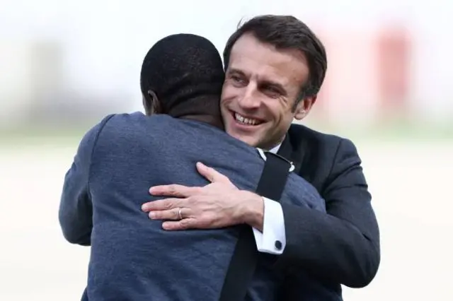 Olivier Dubois hugs Emmanuel Macron.