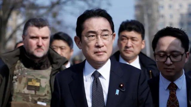 Japanese Prime Minister Fumio Kishida visits a site of a mass grave, in the town of Bucha