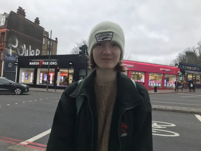 Cara stood outside shops