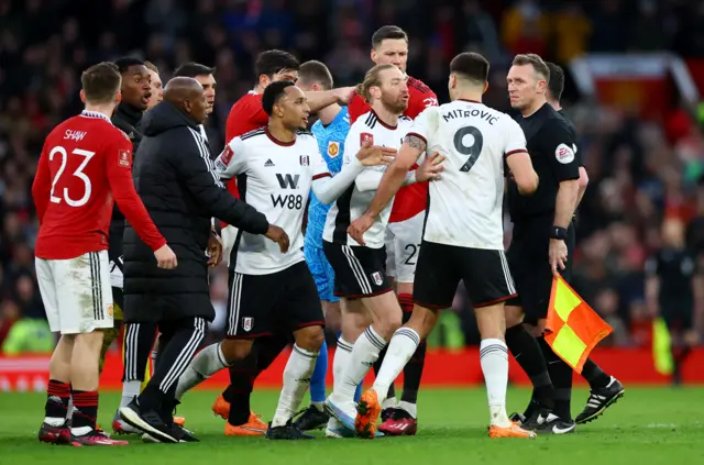 Aleksandar Mitrovic is pushed away by team-mate Tim Ream after confronting referee Chris Kavanagh