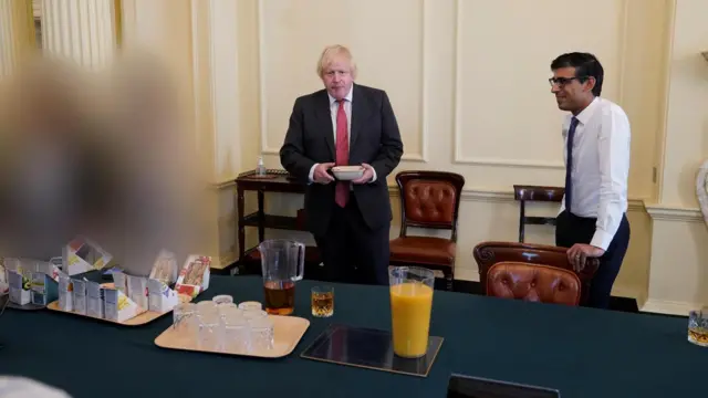 Handout photo dated 19/06/20 issued by the Cabinet Office showing the then prime minister Boris Johnson (left) and the then-Chancellor Rishi Sunak at a gathering in the Cabinet Room in 10 Downing Street on his birthday