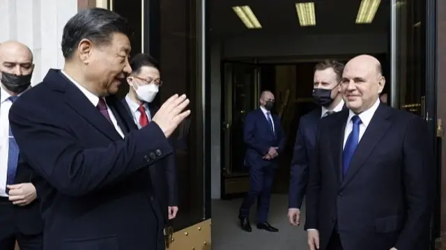 After walking him to the exit, Mishustin says goodbye to Xi as Xi is waving goodbye to the Russian PM.