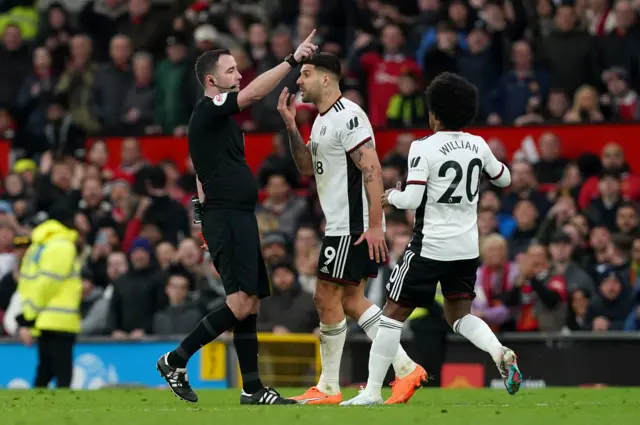 Aleksandar Mitrovic confronts referee Chris Kavanagh at Old Trafford