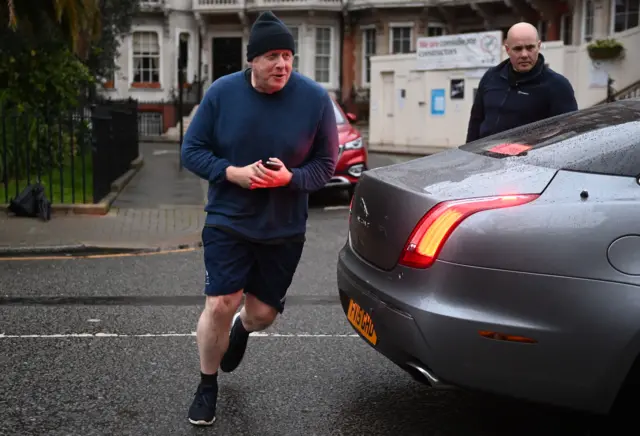 Boris Johnson jogging past car