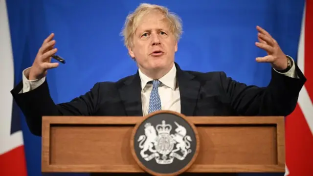 Boris Johnson speaks behind a lectern