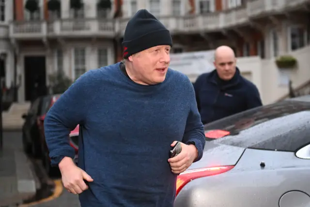 Boris Johnson running with phone in hand