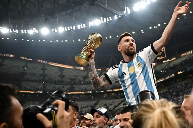 Lionel Messi with the World Cup trophy