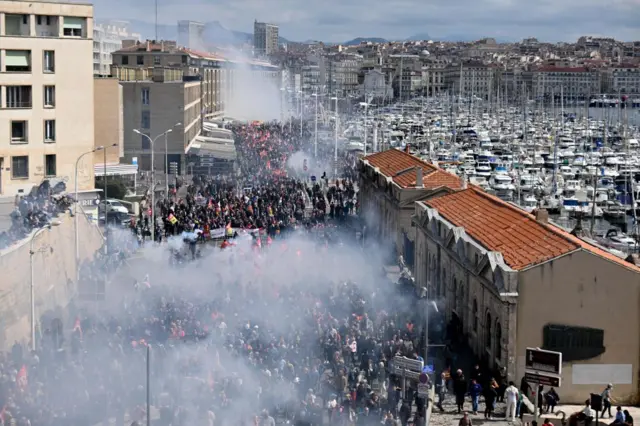 Demonstrators walk on the old port in Marseille during a demonstration