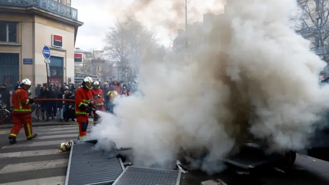 Firefighters extinguish a fire in Paris