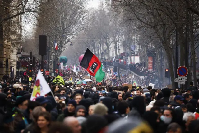 Thousands of protesters march through the streets of Paris