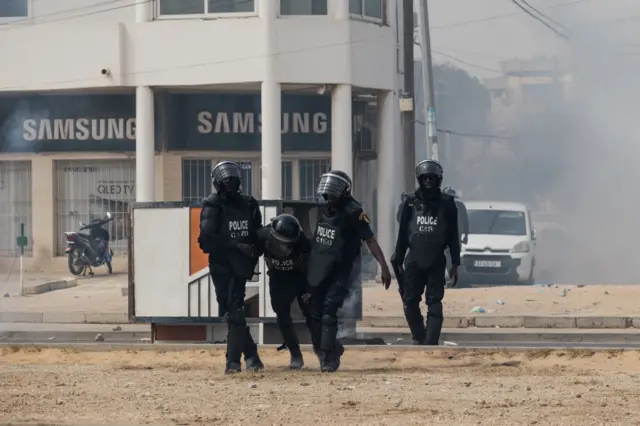 Police officers carry another police officer injured by protesters, on March 16, 2023.