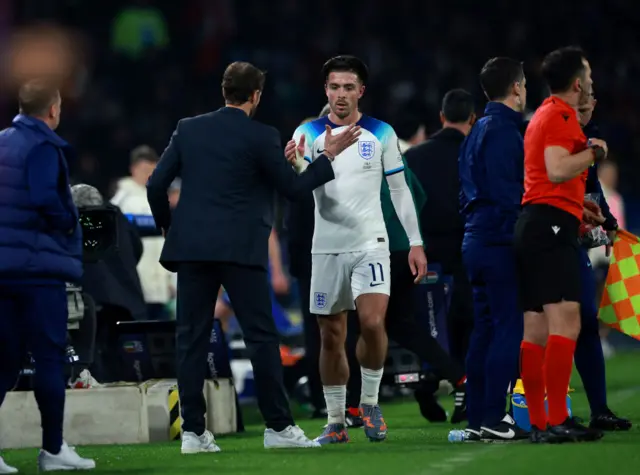 Jack Grealish exchanges a handshake with Gareth Southgate after being substituted