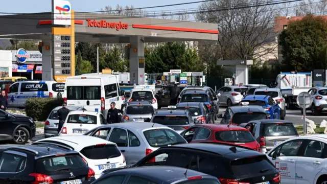 Drivers queue for fuel at a TotalEnergies service station in Marseille, southern France, on March 21, 2023