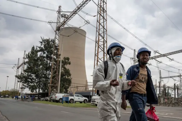 Eskom workers walk at the Lethabo Power Station near Sasolburg, South Africa, on March 23, 202