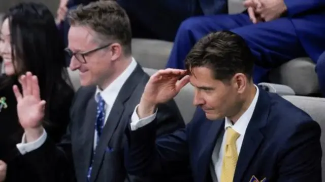 Canadians Michael Kovrig and Michael Spavor react as they are seated before an address from U.S. President Joe Biden in the Canadian House of Commons on Parliament Hill, in Ottawa, Canada,