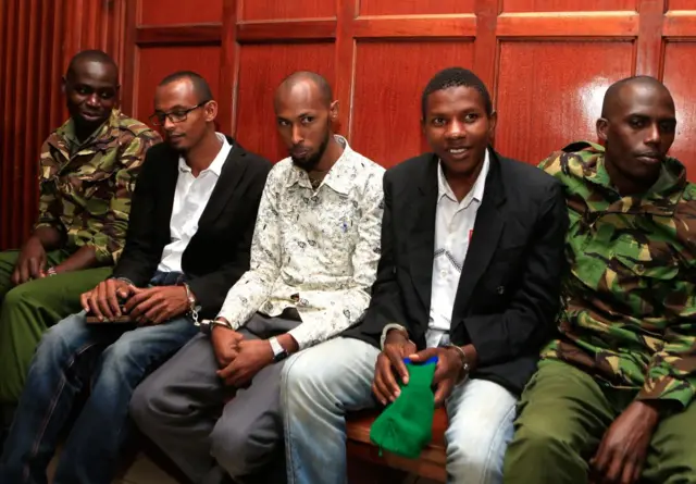 Suspected accomplices Hassan Aden Hassan (2nd L), Mohamed Ali Abdikar (C) and Rashid Charles Mberesero (2nd R) sit and wait for sentencing of abetting Somali jihadists who carried out a 2015 attack on Garissa University in northeast Kenya in which 148 people were kille