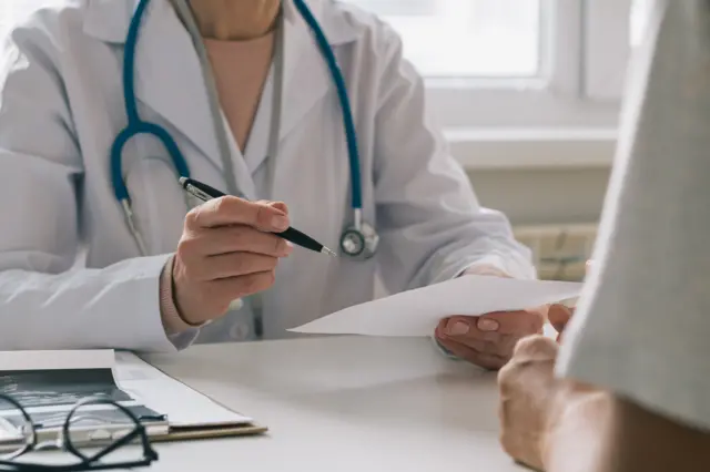 A doctor speaks to a patient