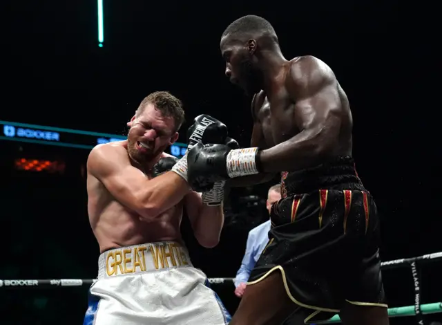 David Light winces under the weight of a punch from Lawrence Okolie