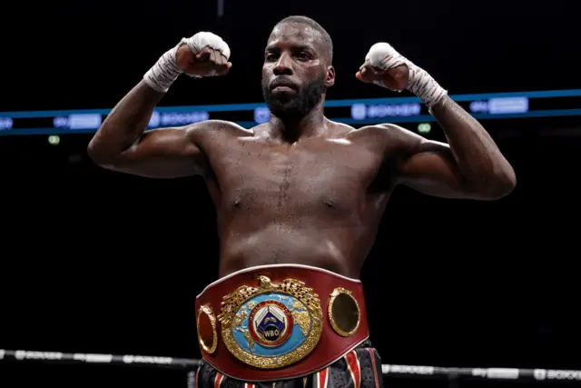 Lawrence Okolie poses with his WBO world title around his waist