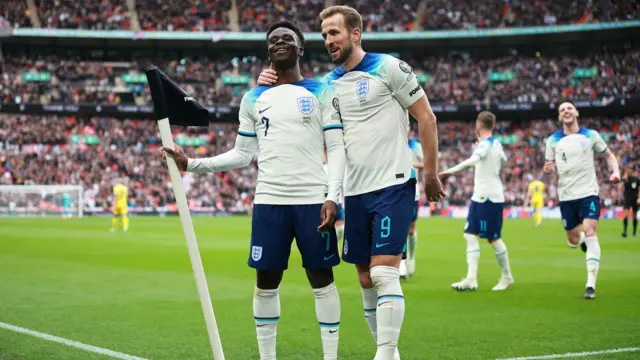 Bukayo Saka and Harry Kane celebrate scoring