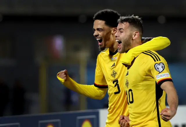 Dion Charles and Jamal Lewis celebrate against San Marino