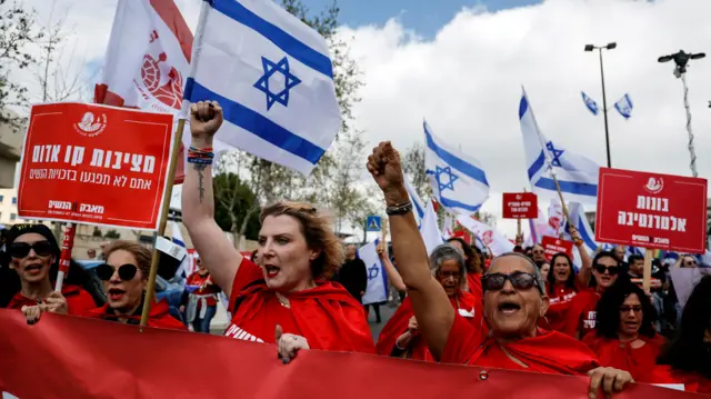 Women dressed as handmaidens from The Handmaid's Tale attend a protest in Israel